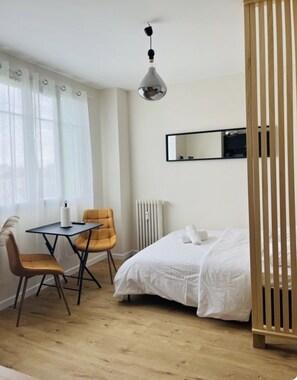 Cozy retreat with a single bed, desk, and modern lighting.