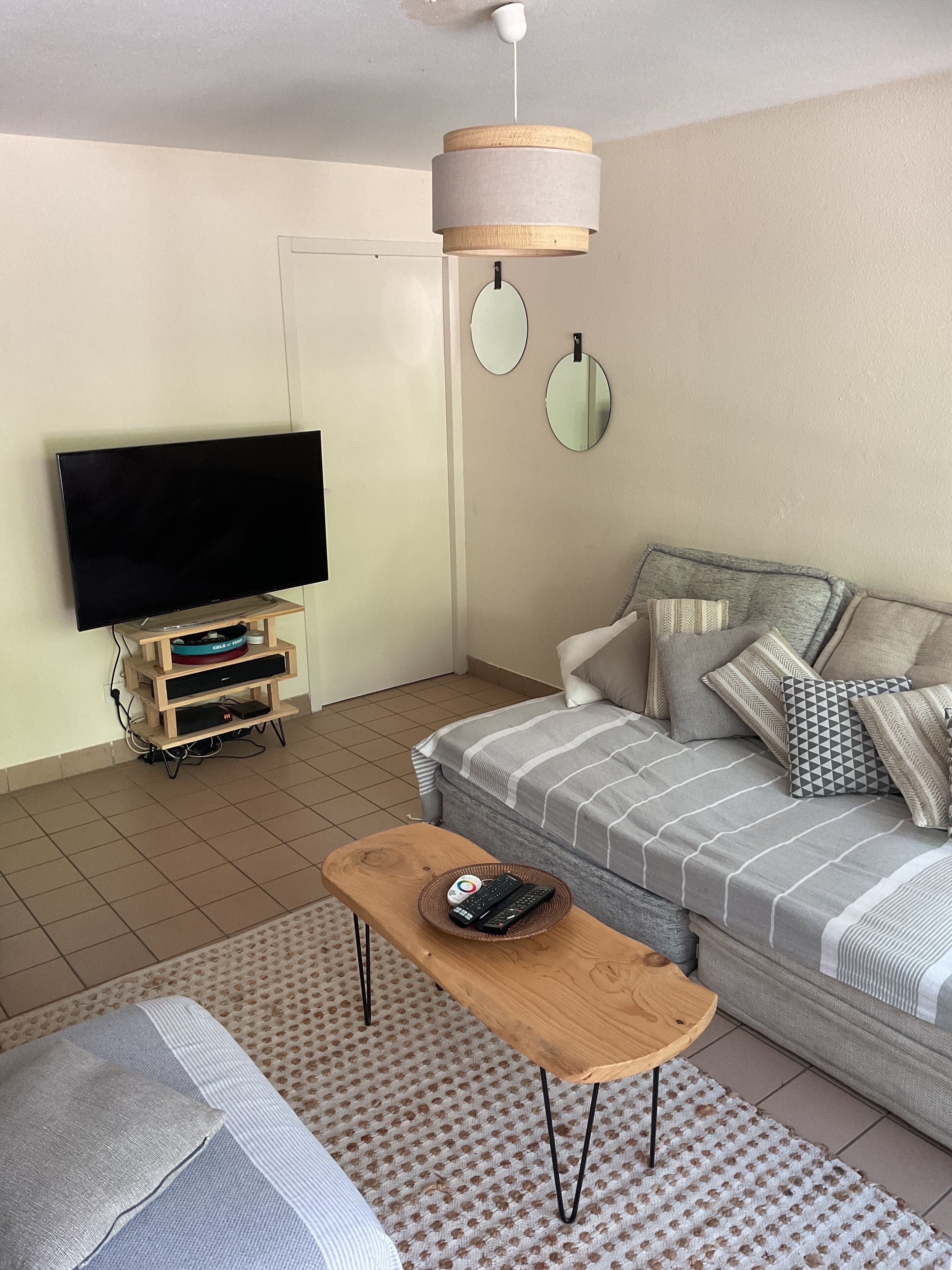 A living room with a TV, sofa, and coffee table.