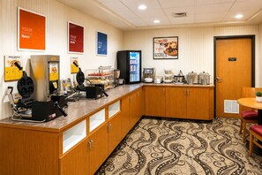 A hotel kitchen with waffle makers, a refrigerator, and a coffee station. - Hotel Mar Vista (Ocean Shores)