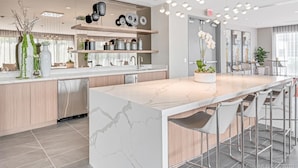 A modern kitchen with a large island, built-in appliances, and a variety of decorative items. - Location, location, location. Best area of Doral (Doral)