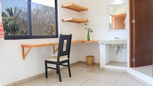 A bathroom with a window, a sink, and a chair. - Yoo Bigu Mazunte (Santa María Tonameca)