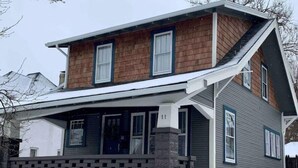 A two-story house with a porch, a brick foundation, and a number '11' on the front. - Boho Bungalow off Main-one block from Lovely Park (Richmond)