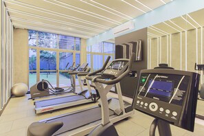 A gym with treadmills, an elliptical, and a heart rate monitor.