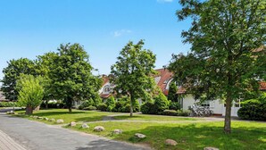 A residential street with houses, trees, and a paved road. - Achterwasser App. 3 by Interhome (Zempin)