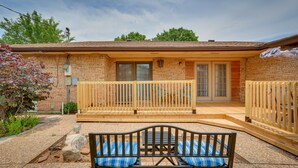 A brick house with a wooden deck, a bench, and a covered patio area. - Lawton Home w/ Deck, Near Casinos + Museums! (Lawton)