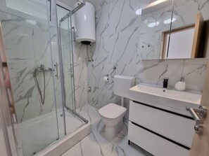 Shower, towels, soap, toilet paper