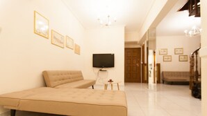 A bedroom with a large bed, a TV mounted on the wall, and a small table with a chair. - Acropolis view! (Athina)