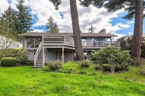 A two-story house with a balcony, a staircase, and a well-maintained lawn. - Family Retreat w Lake & Mt & City View, Gym, MI (Mercer Island)