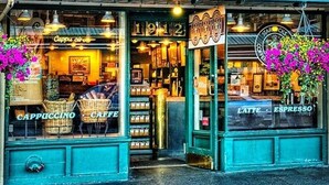 Un Starbucks avec une enseigne ancienne, sur laquelle on peut lire les mots « Cappuccino » et « Caffè » sur les vitrines.