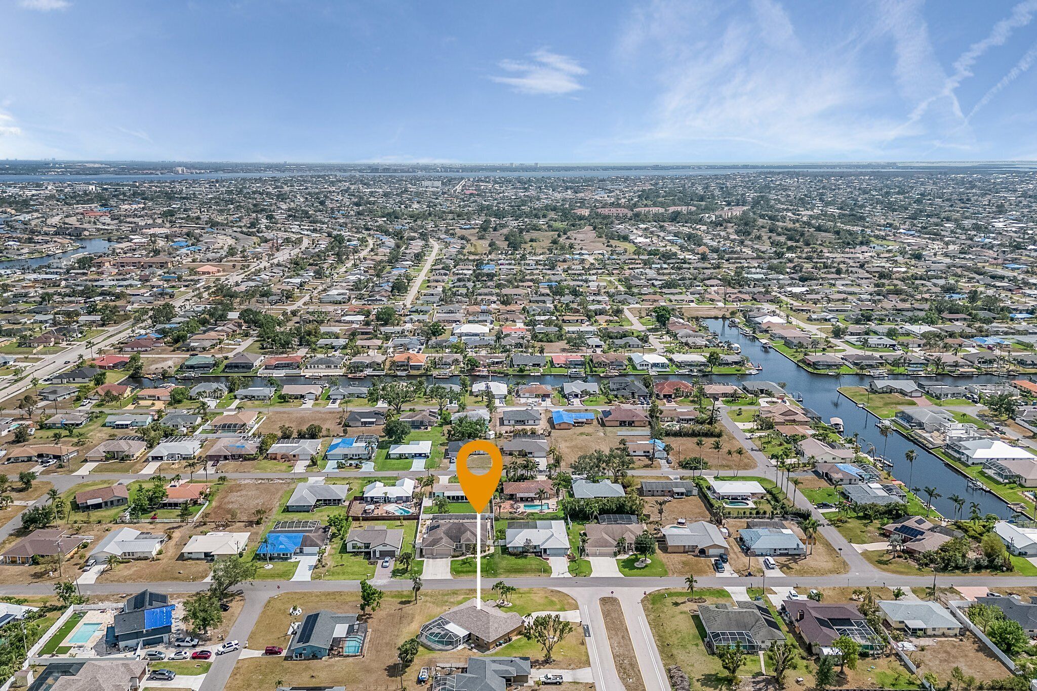 An aerial view of a residential area with a river running through it.