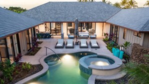 A pool area with lounge chairs, a hot tub, and a dining area with outdoor seating. - Luxury Nohea Home w/ Pool & private 2 BR Ohana
Access to Mauna Lani Sports Club! (Kamuela)