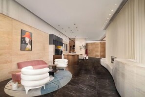 A modern hotel lobby with a curved marble floor, a reception desk, and contemporary seating. - Citadines Apart Hotel (Shanghai Yan'an West Road) (Shanghai)