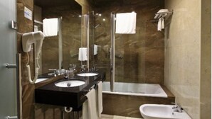 A bathroom with two sinks, a shower, and a bathtub. - Hotel Tiburon (Guadalajara)