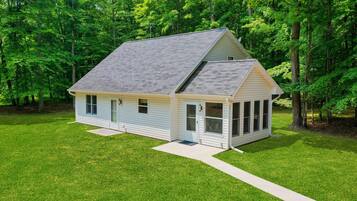 A single-story house with a gabled roof, a front porch, and a small front yard.
