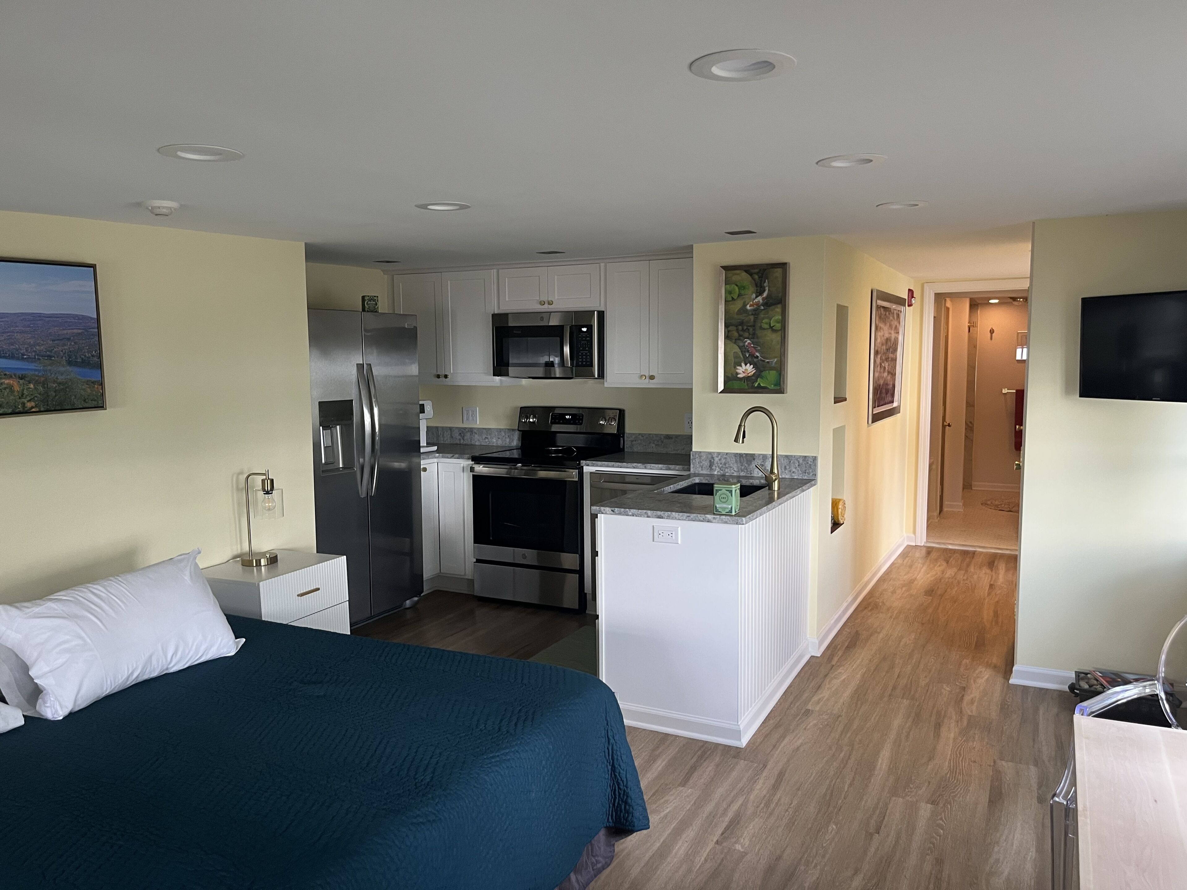 A modern kitchen with white cabinets, stainless steel appliances, and a granite countertop.