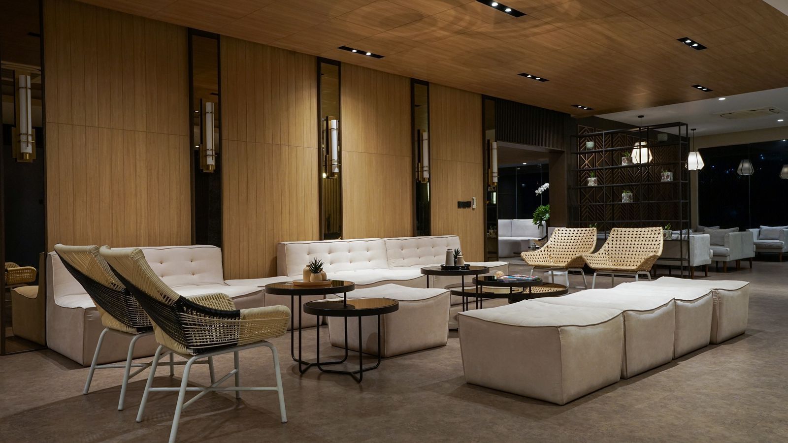 A modern lounge area with a sofa, armchairs, and a coffee table.