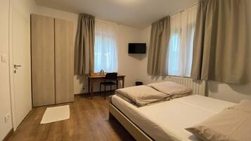 Hypo-allergenic bedding, down duvets, desk, laptop workspace