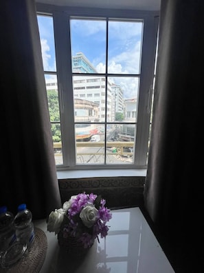 A window with a view of buildings and a street. - Le Hotel Hotel (Phnom Penh)