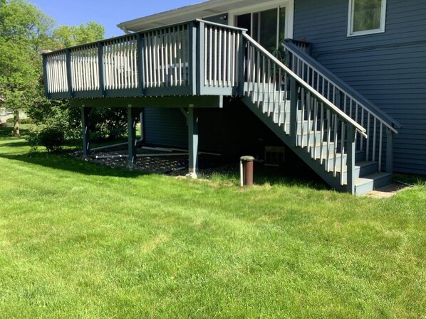 Enjoy a peaceful retreat on this well-maintained property with a spacious deck and lush lawn.