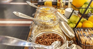 Un bufé de desayuno con diversos alimentos y utensilios.