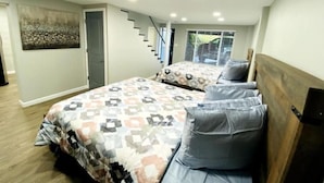 A bedroom with two beds, a staircase, and a painting on the wall. - Cozy Lake View Experience (Klamath Falls)