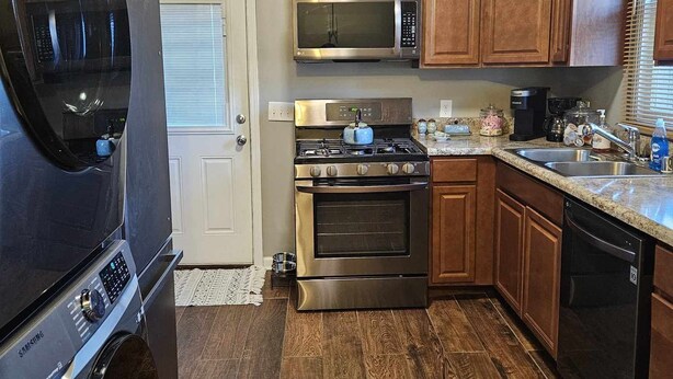A kitchen with a built-in oven, microwave, and stainless steel range. - Cozy Home in Heart of Prestonsburg (Prestonsburg)