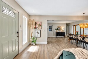 A modern interior with a dining area, a kitchen, and a living space.