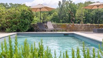 Seasonal outdoor pool, open 9:00 AM to 7:00 PM, pool umbrellas