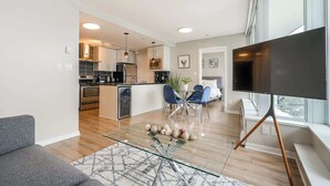 A modern apartment with a kitchen, dining area, and living room.