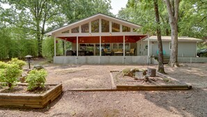 A cabin with a covered porch, a fenced yard, and a small garden. - Arkansas Vacation Rental on Greers Ferry Lake! (Greers Ferry)