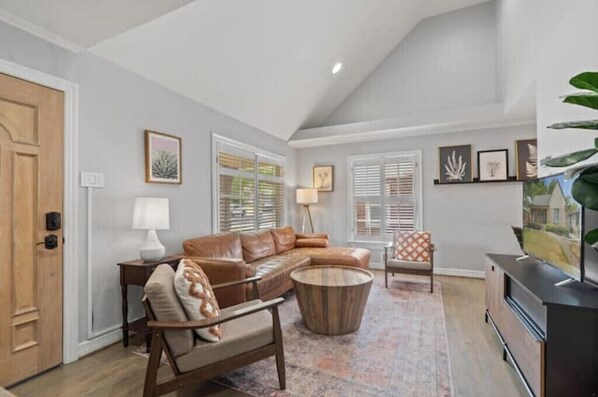 Relax in this inviting living room with a large sofa, coffee table, and TV.