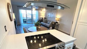 A modern kitchen with a stainless steel stove, oven, and a white countertop. - Minutes from Carlsbad Downtown and Beach (Carlsbad)