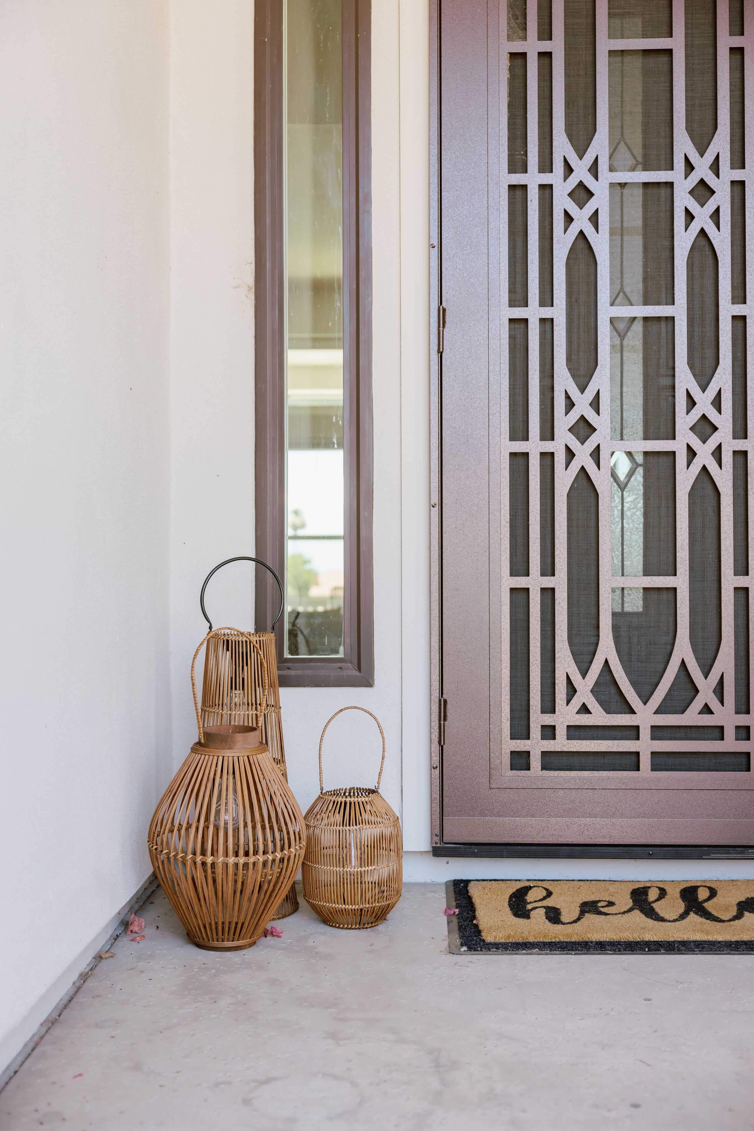 A door with a decorative glass panel and a doormat with "hello" written on it.