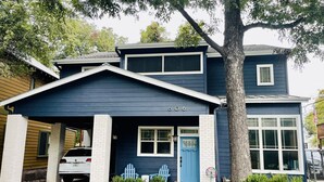 A two-story house with a dark blue exterior, white trim, and a garage.