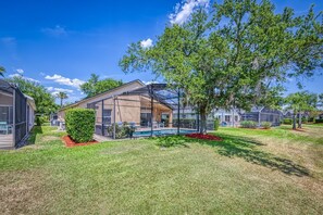 A residential area with modern houses, a swimming pool, and well-maintained lawns.