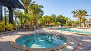 A swimming pool with a 3 FT depth marker, surrounded by palm trees and a covered area. - Spacious 3BR condo in Orlando, perfect for families, near attractions. (Orlando)