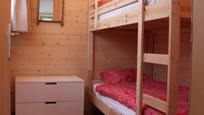 A wooden bunk bed room with a white dresser and a ladder. - Outside: 4-person chalet with balcony, terrace with garden furniture, breathtaking views of the Val (St-Luc)