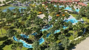 An aerial view of a resort with multiple swimming pools, palm trees, and resort buildings.