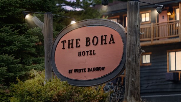 A wooden sign for The Boha Hotel by White Rainbow. - Standard Room w/ King Bed, Balcony, Fireplace, Mountain Views Room #13 (Lake Placid)