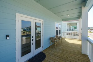 Relax on the covered porch with a comfortable seating area and a beautiful view.