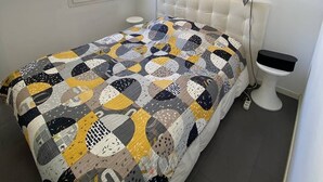 A bedroom with a bed, a window, a mirror, and a toilet. - Charming villa 2 bedrooms swimming pool Wi-Fi air conditioning parking (CANET PLAGE)