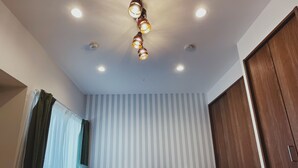 A bedroom with a bed, curtains, a striped wall, and a wooden wardrobe. - Private rental｜Skytree｜36m2｜Max5｜8min. to Station｜3 Station available｜Free Wi-Fi (墨田区)