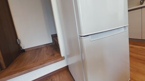 A kitchen with a white refrigerator, wooden flooring, and white walls. - Private rental｜Skytree｜36m2｜Max5｜8min. to Station｜3 Station available｜Free Wi-Fi (墨田区)
