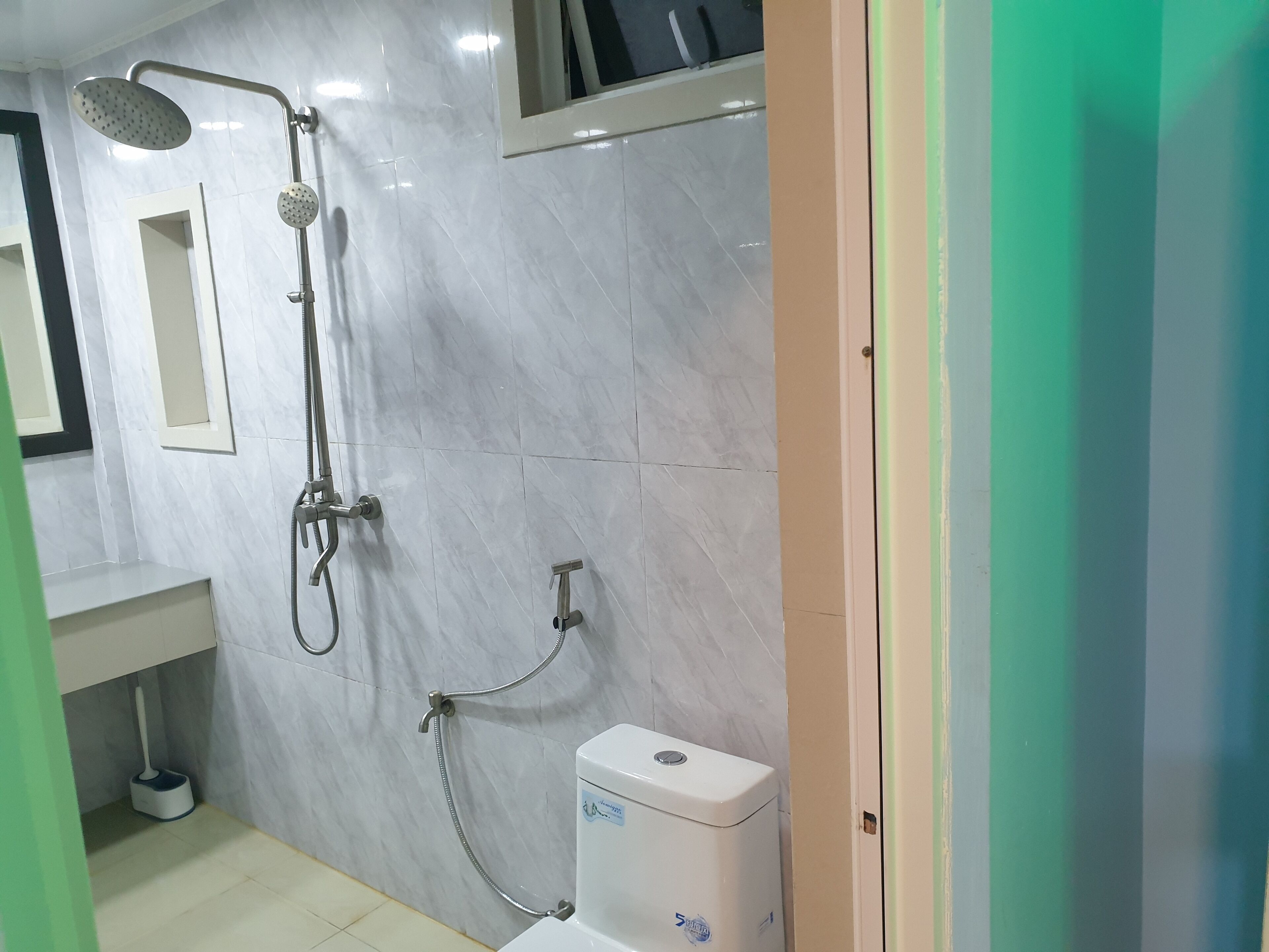 A bathroom with a shower, toilet, and sink.