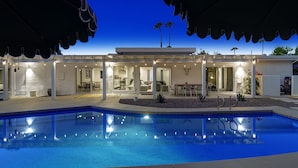 A modern house with a swimming pool, outdoor seating, and a covered patio area. - Spectacular Luce  Desert Escape-  Oversized Resort setting + golf cart (Palm Desert)