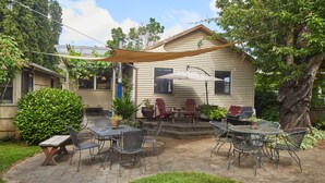 A patio with outdoor furniture, a barbecue grill, and a house in the background. - The Madrona House!
Freshly renovated bungalow / detached studio/office space. (Portland)