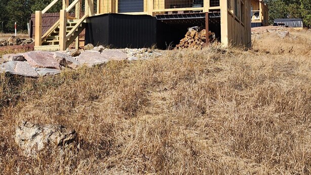A wooden cabin with a balcony, a staircase, and a door. - Teeny Home in the Black Hills! (Custer)