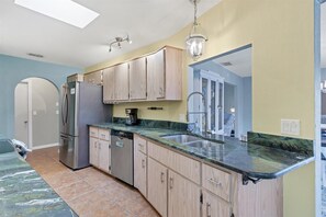 Kitchen features stainless steel appliances, an oven, and a range hood.