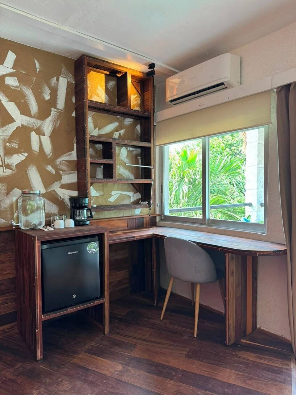A corner room with a desk, chair, and built-in shelves.