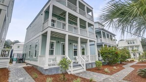 A multi-story building with a porch and multiple balconies. - Private *Heated Pool | Free Golf Cart | New Home | Patio Area | 5 Outdoor Spaces | Game Table (Santa Rosa Beach)